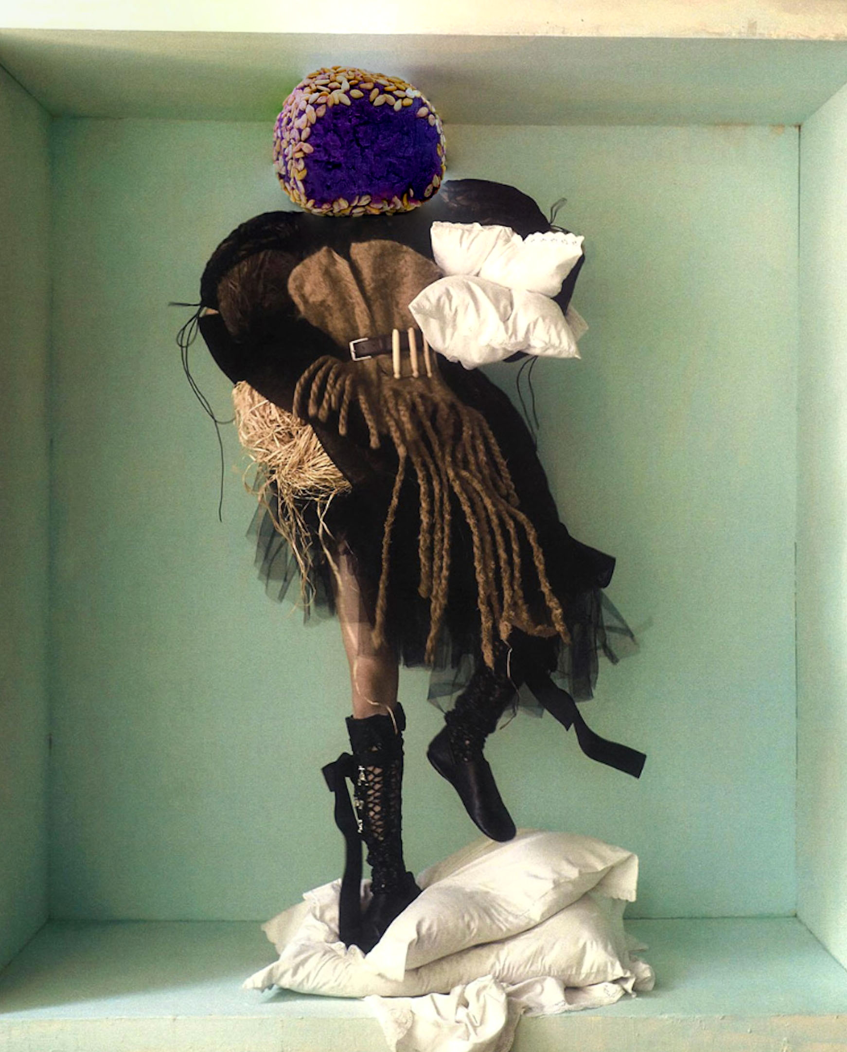 woman in black and brown outfit standing on pillows